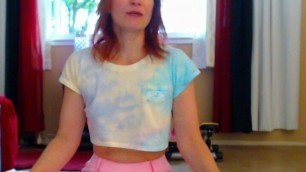 Aurora Willows stretching in pink pants and crop top